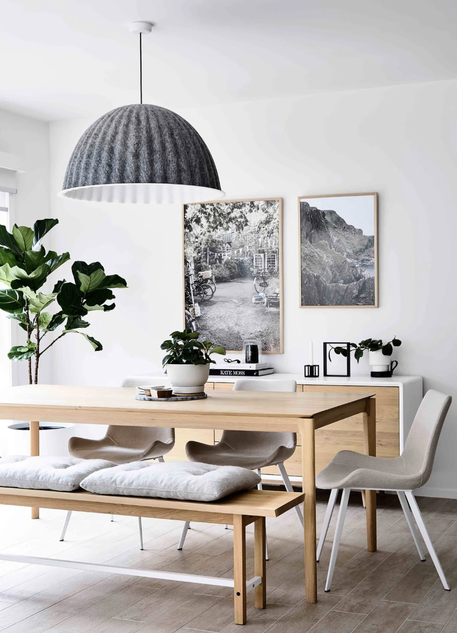 Neutral dining space with oversized pendant light